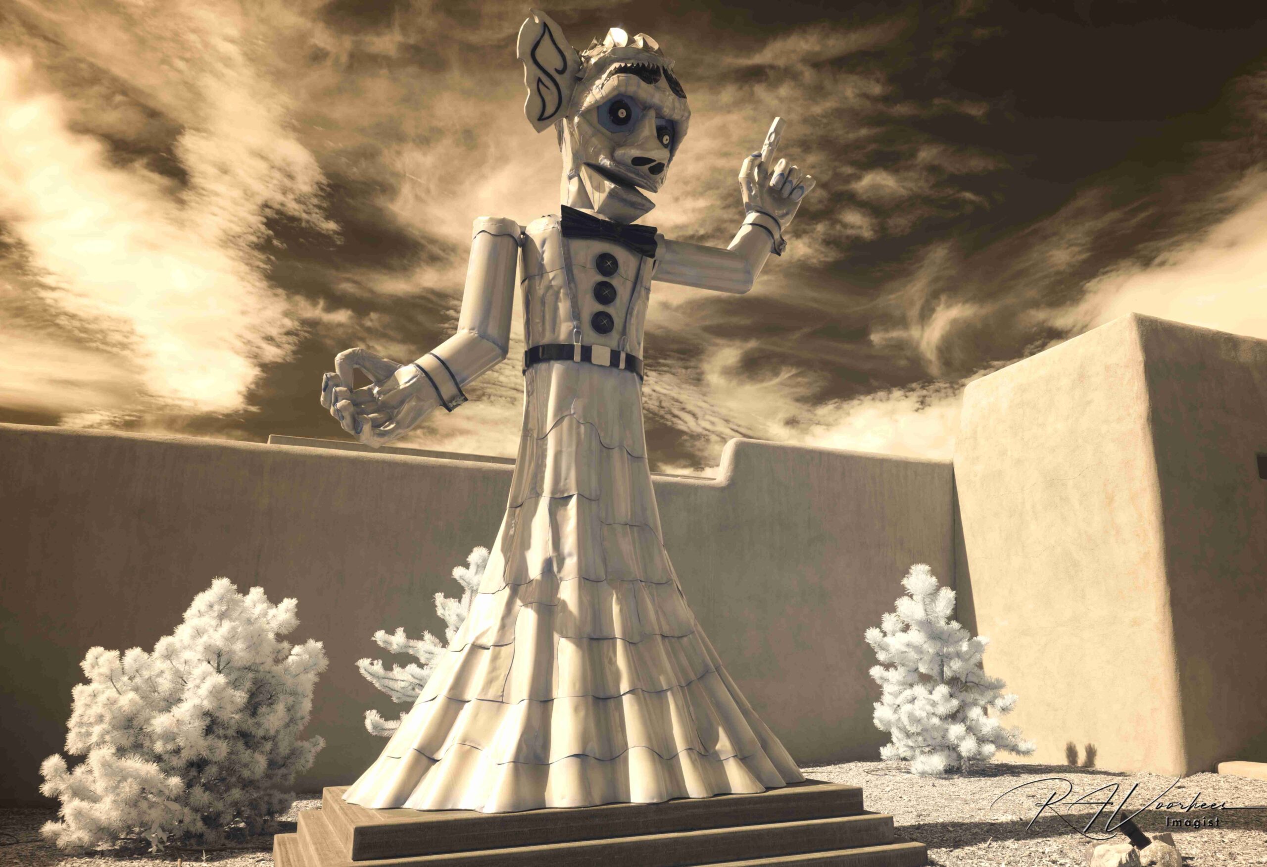 Zozobra, Old Man Gloom, before the burning, against adobe walls and a wild sky, in infrared